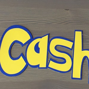 May include: A yellow and blue banner with the name "Cash" in large, stylized letters. The banner is decorated with a red and white Pokeball on the left and a yellow cartoon Pikachu on the right.