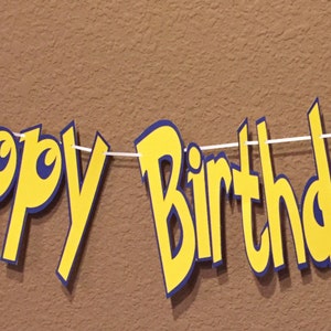 May include: A yellow and blue "Happy Birthday" banner featuring a red and white Pokeball and a yellow Pikachu character.