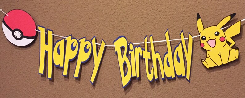 May include: A yellow and blue "Happy Birthday" banner featuring a red and white Pokeball and a yellow Pikachu character.