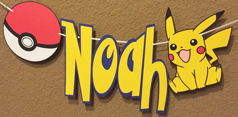May include: A yellow and blue banner with the name "Noah" in large, bold letters. The banner also features a red and white Pokeball and a yellow Pikachu character.