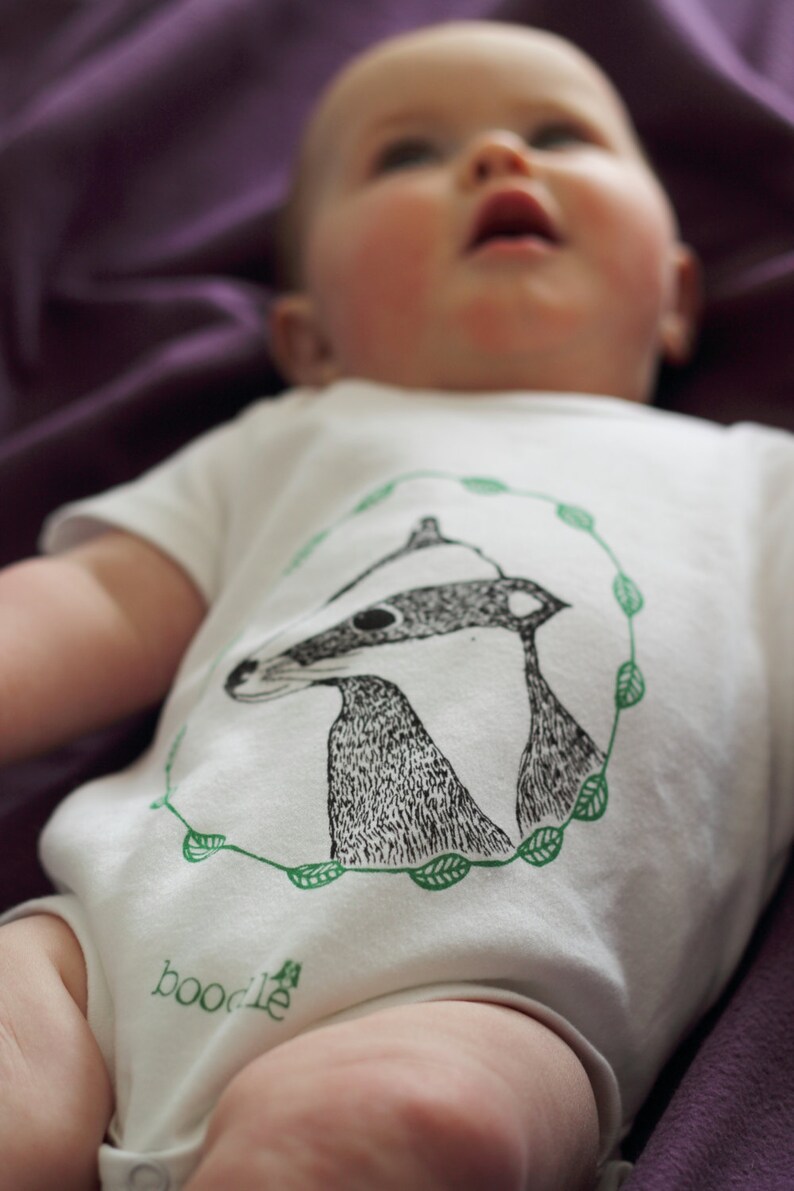 Featuring /'Betty the Badger/' in a circle of leaves. hand screen printed with eco-friendly inks Organic Badger Baby grow