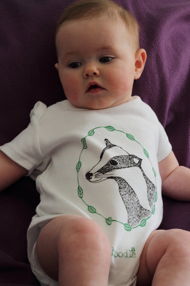 Featuring /'Betty the Badger/' in a circle of leaves. hand screen printed with eco-friendly inks Organic Badger Baby grow