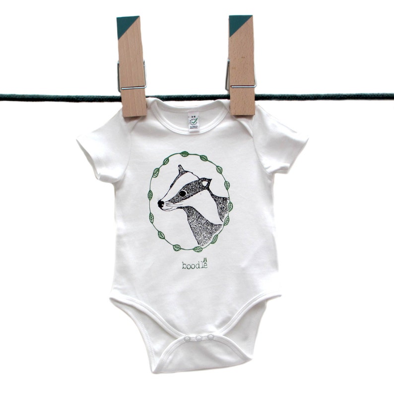 Featuring /'Betty the Badger/' in a circle of leaves. hand screen printed with eco-friendly inks Organic Badger Baby grow