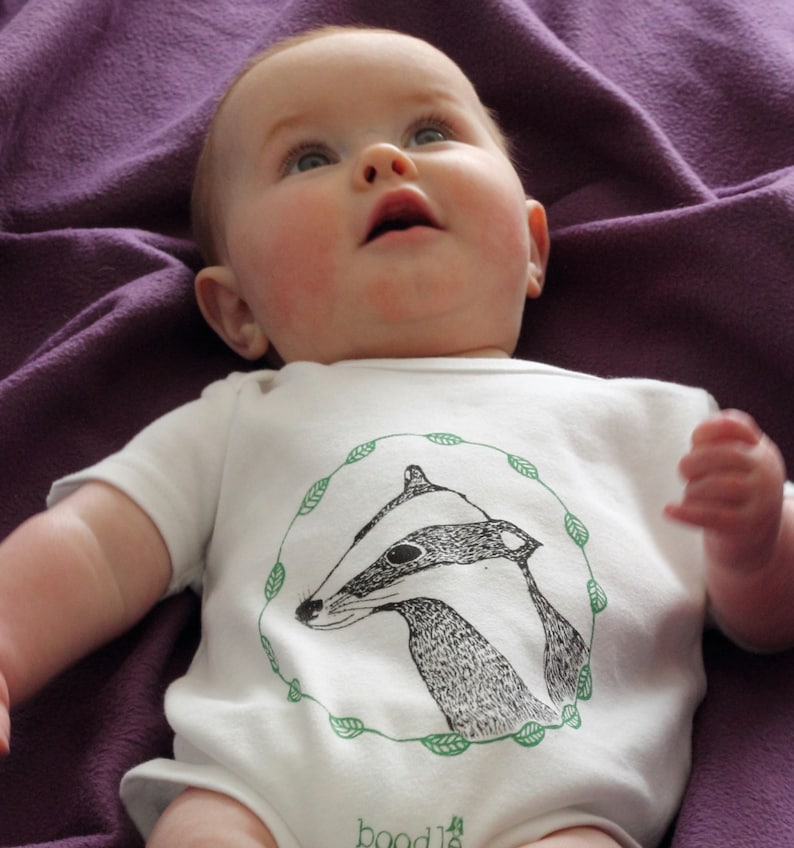 Featuring /'Betty the Badger/' in a circle of leaves. hand screen printed with eco-friendly inks Organic Badger Baby grow