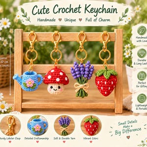 May include: Four crochet keychains hanging on a wooden stand, featuring a blue watering can, a red mushroom, a purple lavender bouquet, and a red strawberry. Each keychain has a gold lobster clasp and measures approximately 8-10 inches long.