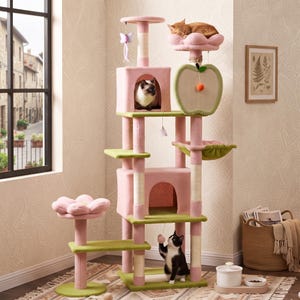May include: A multi-level cat tree featuring pink and green platforms, two enclosed cubbies, a flower-shaped perch, and an apple-shaped scratching post. Three cats are interacting with the structure, which includes hanging toys and sisal-wrapped posts.