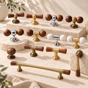 May include: A collection of cabinet hardware including T-bar pulls, round knobs, and a drop pull. The pieces feature combinations of dark wood, brushed brass, polished chrome, and white marble accents, showcasing various shapes and finishes.