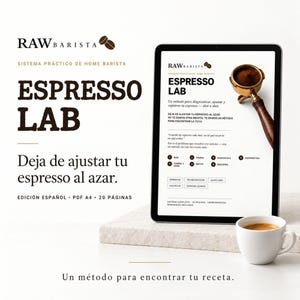 May include: A digital tablet displays the Raw Barista Espresso Lab guide, featuring text in Spanish, a coffee portafilter graphic, and a numbered process list. A white ceramic cup of espresso sits nearby, with the title text repeated on the left side.