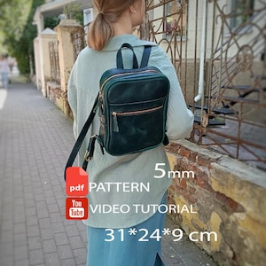 May include: A dark green leather backpack with a top handle, adjustable shoulder straps, and a front zippered pocket. The image includes text: pdf PATTERN, 5mm, YouTube VIDEO TUTORIAL, and dimensions of 31*24*9 cm.