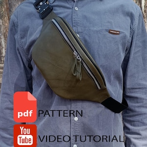 Peut inclure: Un sac banane en cuir vert olive doté d'une boucle tactique noire, d'une fermeture éclair en métal argenté avec deux tirettes en cuir et d'une sangle noire réglable. L'image contient le texte PDF PATTERN et YouTube VIDEO TUTORIAL.