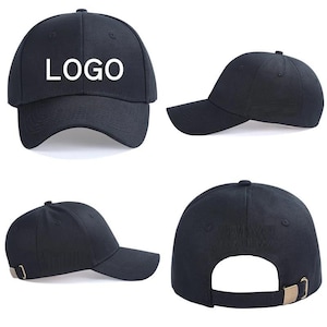 May include: A black baseball cap featuring the word "LOGO" in white capital letters on the front panel. The cap has a curved brim, a structured crown, and an adjustable strap at the back with a metallic buckle. The design is shown from multiple angles.