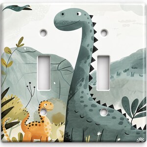 May include: A square double light switch wall plate featuring a printed illustration of a large teal long-necked dinosaur and a smaller orange spotted dinosaur in a landscape with green hills, foliage, and a flying bird against a white background.