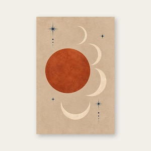 May include: A rectangular wall art print on a beige background featuring a large, textured terracotta-colored circle in the center. Surrounding the circle are three cream-colored crescent moon shapes, along with two dark blue star icons and dots.