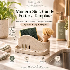 May include: A beige speckled ceramic sink caddy with a rectangular slot holding a green and yellow sponge and a circular slot holding a wooden dish brush. The caddy features vertical drainage slits on the front and a base tray for water collection.