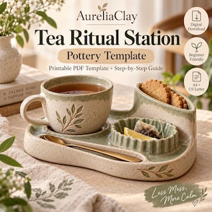 May include: A ceramic tea ritual station pottery template featuring a speckled cream and sage green finish. The set includes a cup, a scalloped tea bag holder, and a snack compartment. Text reads AureliaClay Tea Ritual Station Pottery Template.