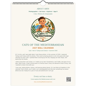 May include: A 2027 wall calendar titled Cats of the Mediterranean by Arin. The cover features a circular illustration of a child holding an orange cat, with text detailing the photographer's journey through Türkiye and Greece in 2026.