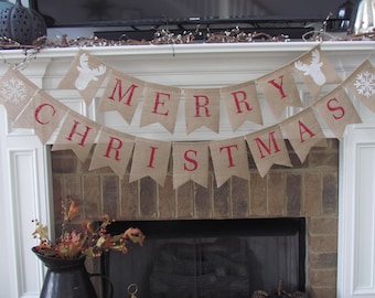 May include: A burlap banner with the words "Merry Christmas" in red letters. The banner is decorated with white snowflakes and reindeer silhouettes.