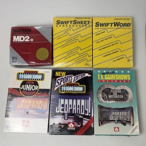 Peut inclure: Une collection de six boîtes de logiciels vintage comprenant un pack de disquettes Maxell 5,25 pouces, SwiftSheet et SwiftWord pour Commodore 64/128, et trois titres de jeux télévisés : Jeopardy Junior Edition, Jeopardy Sports Edition et Wheel of Fortune.