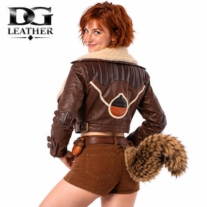 May include: A brown leather jacket with a cream-colored faux fur collar, featuring a quilted back panel, a circular emblem, and buckled cuffs. The outfit includes brown shorts with a leather belt and a detachable faux fur tail accessory.