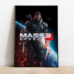 May include: A rectangular poster featuring the Mass Effect 3 video game cover art. It displays a soldier in black N7 armor standing against a backdrop of a burning planet and space. The title Mass Effect 3 is printed in white and red text.