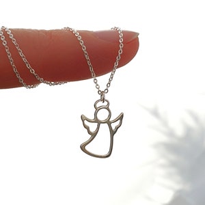 May include: A silver chain necklace with a delicate angel pendant. The angel is outlined in silver and has a halo.