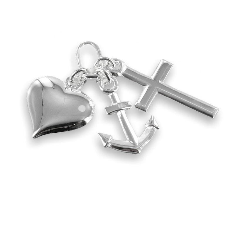 May include: A silver charm pendant featuring a heart, an anchor, and a cross. The heart is smooth and rounded, the anchor has detailed lines, and the cross is a simple, classic design. The pendant is on a white background.