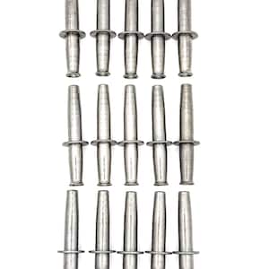 May include: A collection of fifteen identical silver-toned metal pins arranged in three rows of five. Each pin features a cylindrical body with a tapered end and a flat, circular disc positioned around the center of the shaft, creating a uniform look.