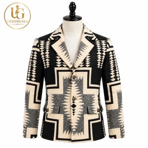 May include: A blazer featuring a bold black, cream, and grey geometric pattern. The garment has a notched lapel, a three-button front closure, and two flap pockets at the waist. The design includes repeating triangular and cross-shaped motifs.