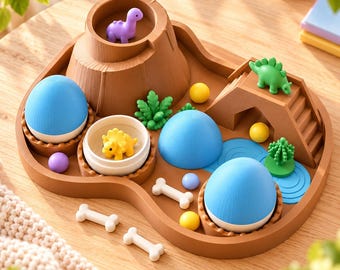 May include: A brown plastic dinosaur playset featuring a central volcano, a bridge with a green dinosaur, three blue and white egg-shaped structures, small yellow and purple spheres, white bone-shaped pieces, and green plant figurines.