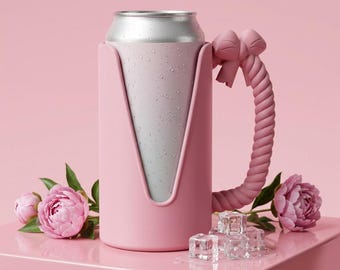 May include: A matte pink beverage can cooler sleeve with a rope-textured handle and a decorative bow at the top. The sleeve holds a silver aluminum can covered in condensation droplets, positioned between two pink peony flowers and clear ice cubes.