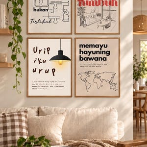 May include: Four framed wall art prints with light backgrounds. The top left features puzzle pieces and text. The top right shows a room illustration with red text. The bottom left displays a black pendant lamp and text. The bottom right shows a world map and text.