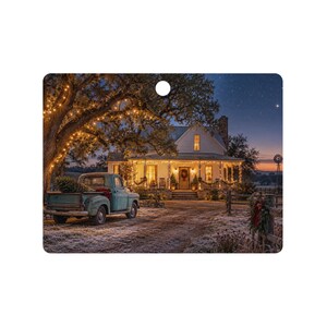 May include: A rectangular ornament featuring a nighttime scene of a white farmhouse with a lit porch, a vintage teal pickup truck carrying a pine tree in the bed, and a large tree draped in warm string lights under a starry twilight sky.