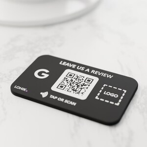 May include: A rectangular black sign with rounded corners featuring the white text LEAVE US A REVIEW, a Google G icon, a QR code, a contactless symbol with the text TAP OR SCAN, a dashed box labeled LOGO, and the brand name LOHIK.