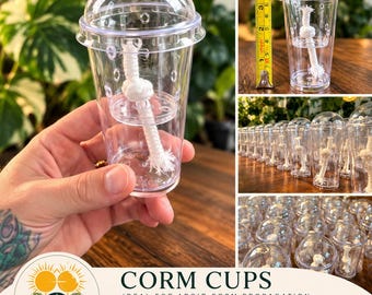 May include: A clear plastic cup with a dome lid and a white cotton wick for plant propagation. The cup features ventilation holes and a self-watering design. A yellow measuring tape shows the cup is approximately 4 inches tall.