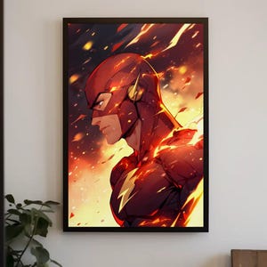May include: A framed wall art print featuring a side profile of a superhero wearing a red mask and suit with a yellow lightning bolt emblem on the chest. The background is a dynamic display of orange and yellow flames and glowing light particles.