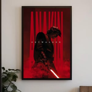 Op de afbeelding: Een ingelijste verticale poster met een donker silhouet van een persoon in gewaad die een gloeiend lichtzwaard vasthoudt. De achtergrond is dieprood met rookeffecten. Het woord ANAKIN staat in grote, dikke, verticale rode letters gedrukt.