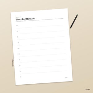 May include: A white paper checklist titled Morning Routine with ten horizontal lines and small square checkboxes on the left side. A thin black pen is positioned diagonally near the top right corner of the page. The word LeafKit is printed in the bottom right corner.