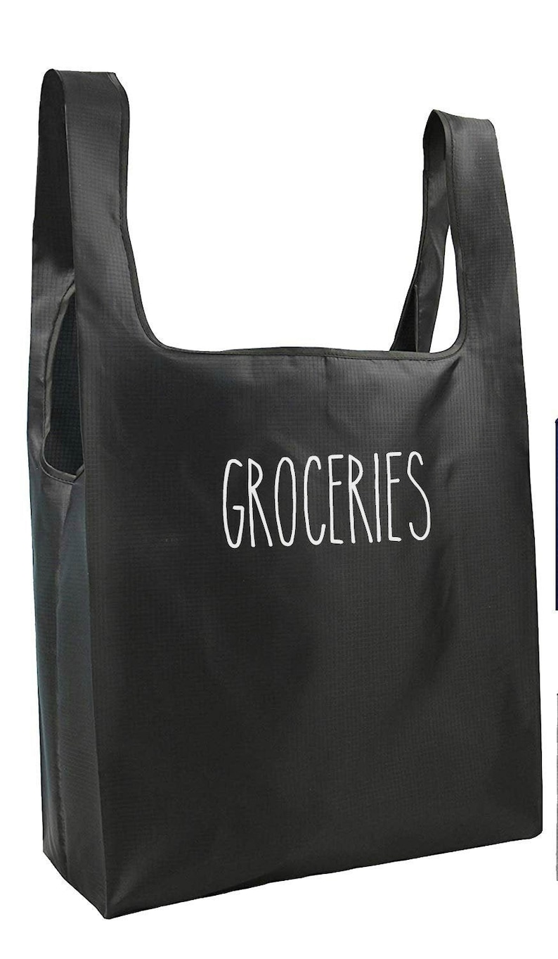 May include: A black reusable grocery bag with white text that says "GROCERIES".