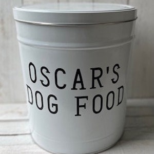 May include: White metal dog food container with a black label that reads "Oscar's Dog Food".