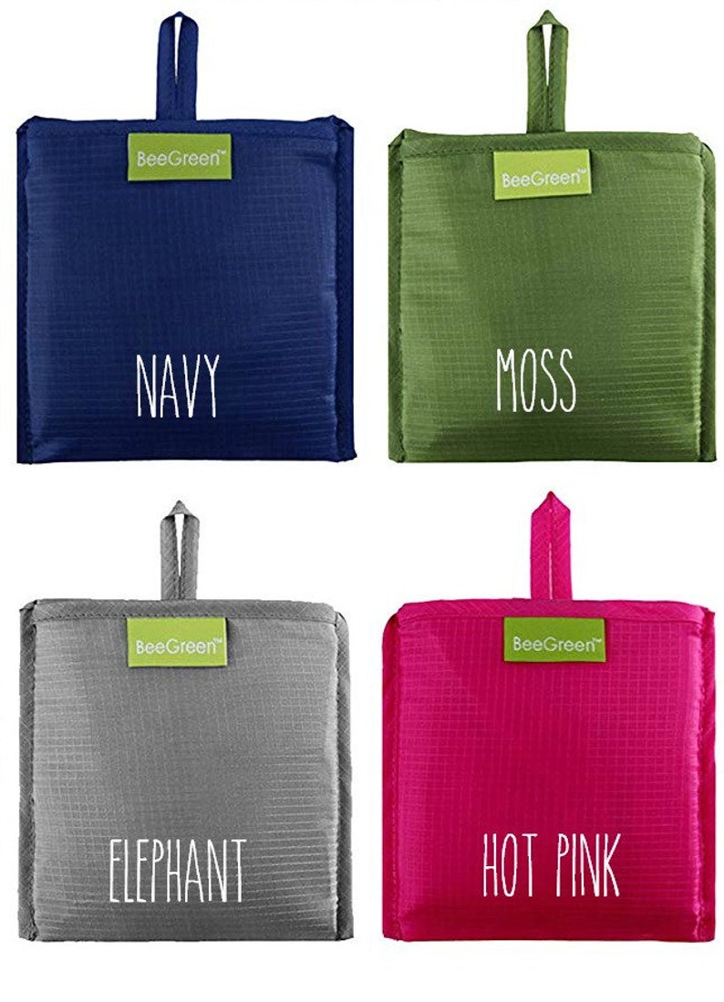 May include: Four reusable shopping bags in different colors: navy blue, moss green, gray, and hot pink. Each bag has a white label with the text "BeeGreen" and the color name printed in white.