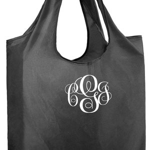 May include: A black reusable shopping tote bag with a white monogram of the letters "CGS".