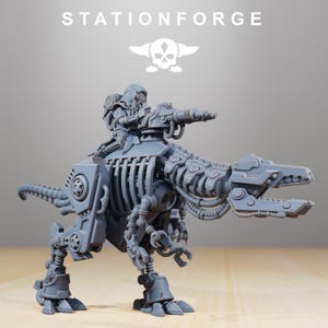 May include: A grey resin miniature of a mechanical dinosaur-like creature with exposed ribcage plating, robotic limbs, and a mounted cannon. A hooded figure sits on the back, operating the weapon. The text STATIONFORGE appears above the figure.