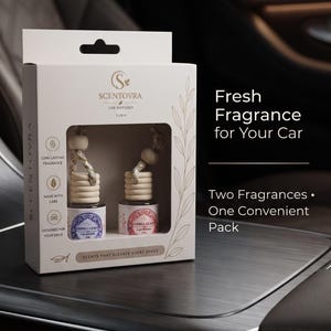 May include: A white rectangular box containing two 8 mL car diffusers with wooden caps and hanging cords. The packaging features the text 2 x 8 mL Car Diffusers, Scentovra, Fresh Fragrance for Your Car, and Two Fragrances One Convenient Pack.