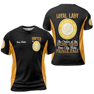 May include: A black and gold short-sleeve t-shirt featuring the text Loyal Lady, The Order of the Golden Circle, United No. 2 Assembly, Your Name, Your City, State, and Prince Hall, with circular emblems displaying a bird graphic.