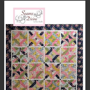 May include: A quilt pattern called "Meadow Garden" by Seams Divine. The quilt is made with a variety of floral fabrics in pink, green, yellow, and blue. The quilt is bordered with a dark blue fabric with a floral print.