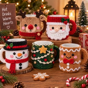 May include: Five ceramic mugs featuring festive crochet cozies. Designs include a brown reindeer with a scarf, a Santa Claus with a beard, a snowman with a black hat and red scarf, a green Christmas tree with a star, and a gingerbread person.