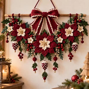 May include: A crocheted wall hanging featuring deep red poinsettia flowers with cream centers, green leaves, and small pinecone accents. A large red bow with cream trim sits at the top, suspended from a wooden rod with hanging red berry clusters.