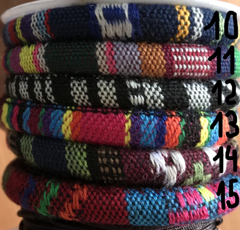 Puede incluir: Una pila de pulseras tejidas de colores con los n&uacute;meros del 10 al 15 impresos en el lado derecho de la imagen.