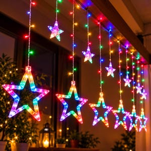 May include: A set of hanging string lights featuring multiple illuminated star-shaped ornaments. The stars are outlined in vibrant, multi-colored LED lights, including red, green, blue, and yellow hues, suspended from thin wires in a vertical arrangement.