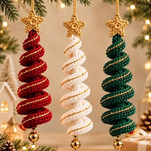 May include: Three spiral-shaped hanging ornaments in red, white, and dark green. Each piece features a crocheted texture, a gold-colored star at the top, a thin gold thread spiraling around the body, and a small gold sphere at the bottom.